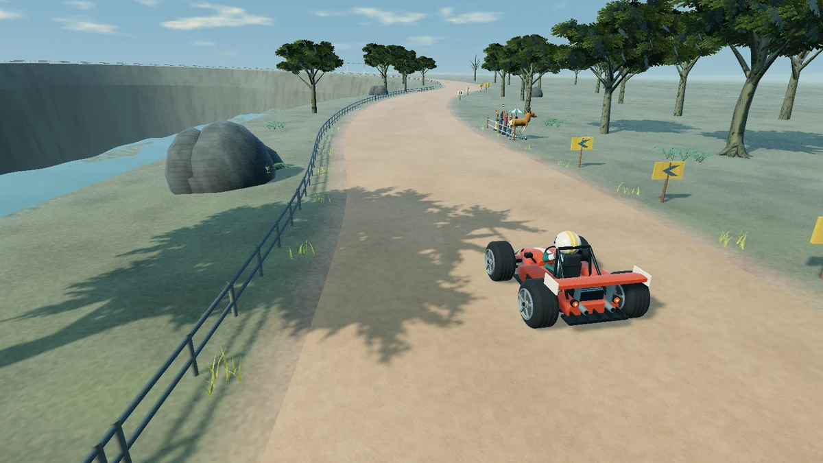 Coral kart on a winding circuit beside a layered gorge
